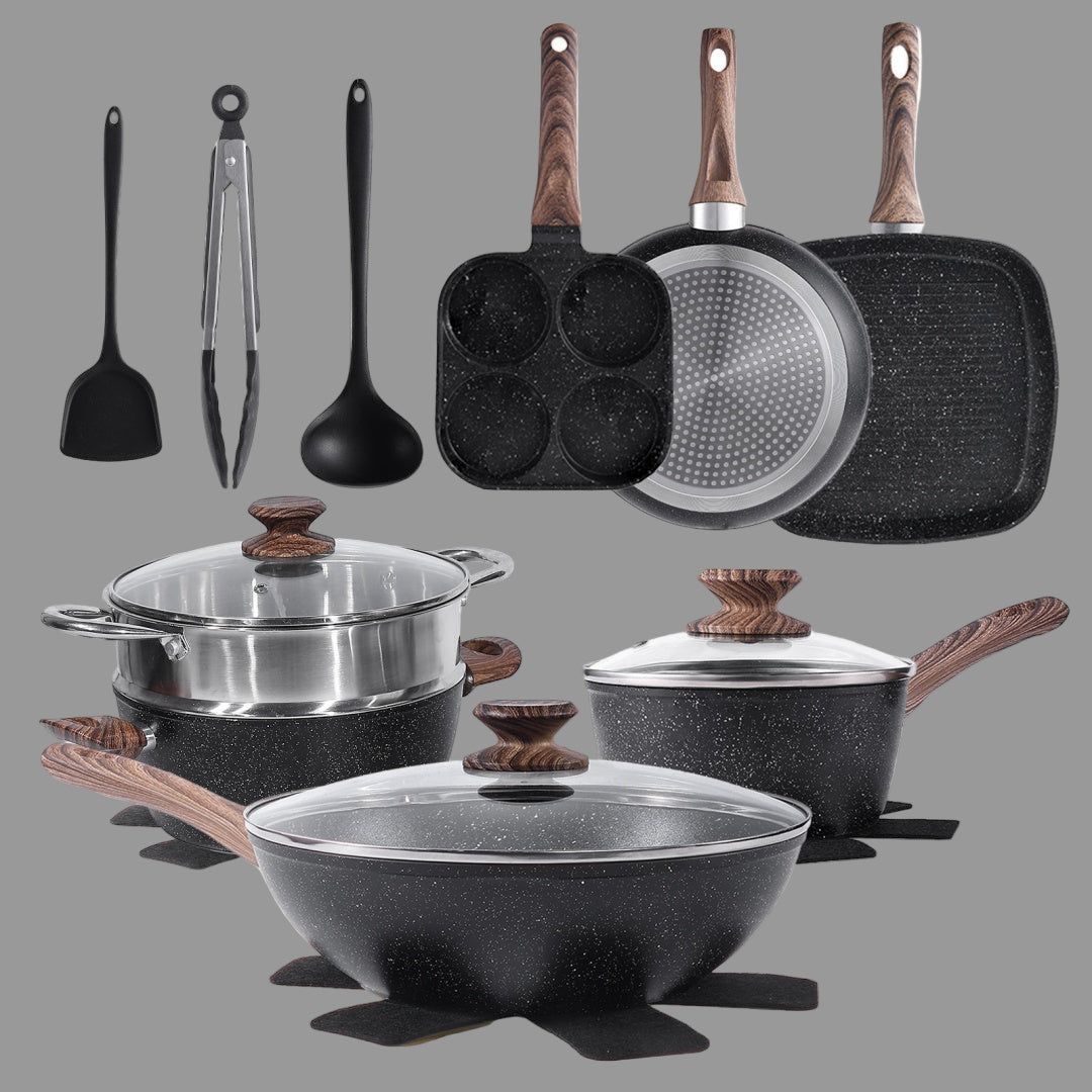 Set of kitchen cookware including pots, pans, and utensils on a white background